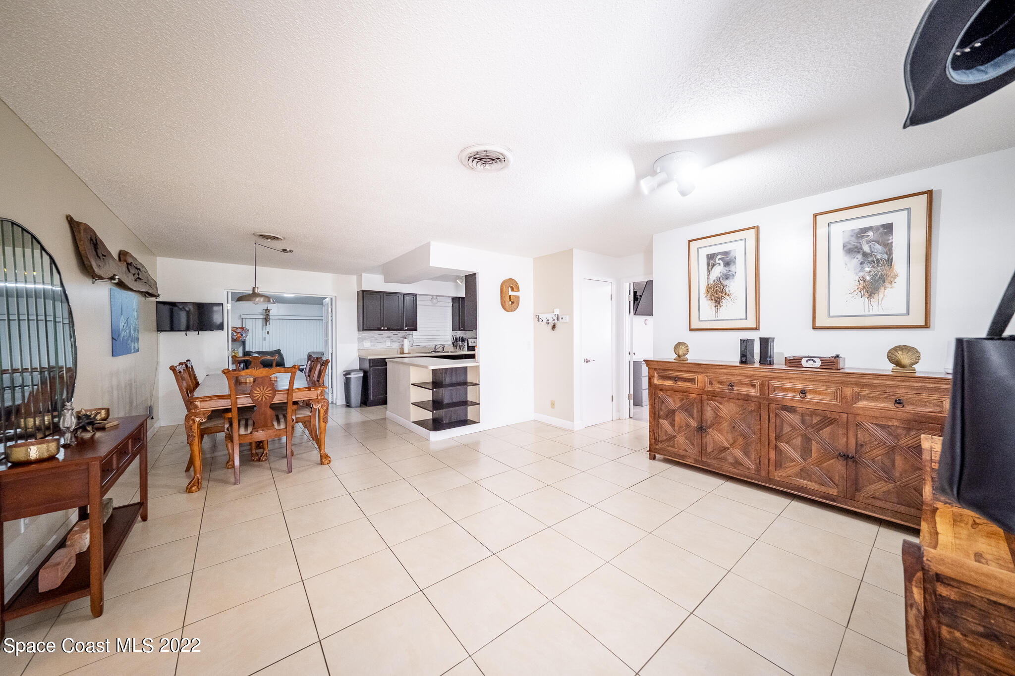982 Cardon Drive Rockledge, FL 32955 - Photo 6 of 27 a living room with furniture and a flat screen tv