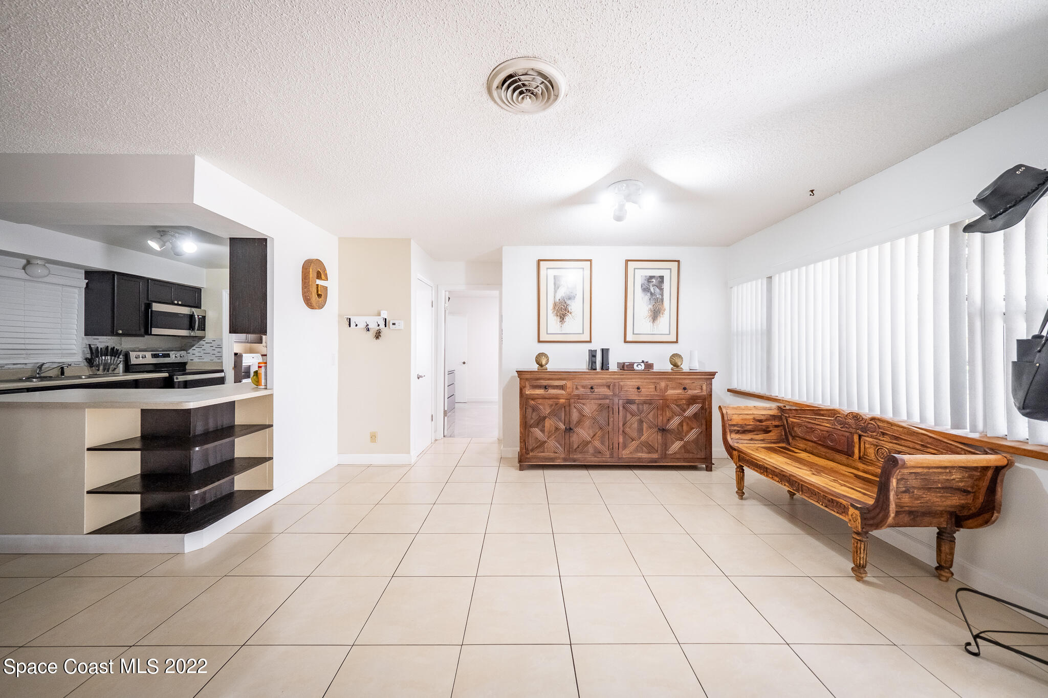 982 Cardon Drive Rockledge, FL 32955 - Photo 7 of 27 a living room with furniture and a open kitchen view