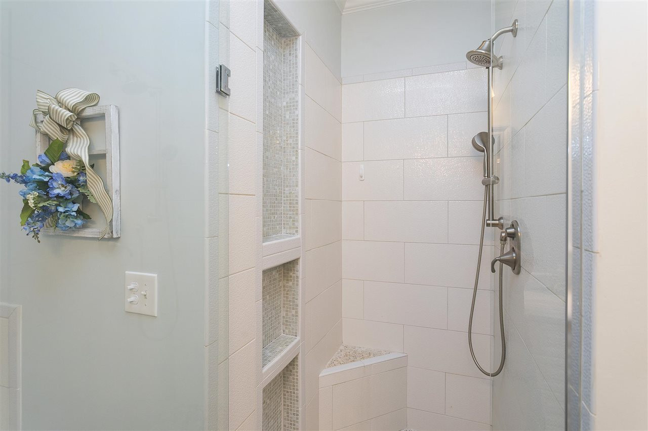 8216 Lloyd Allyns Way Raleigh, NC 27615 - Photo 13 of 30 Pretty tile detailing in the updated shower w frameless door. Master Bath/Spa