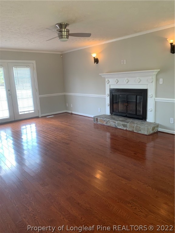 4520 Mobius Road Fayetteville, NC 28312 - Photo 2 of 29 an empty room with wooden floor and fireplace