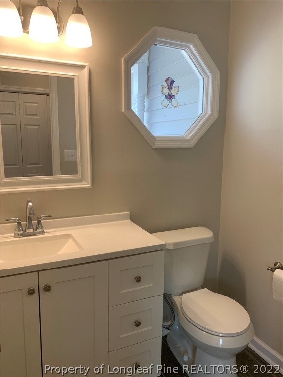 4520 Mobius Road Fayetteville, NC 28312 - Photo 8 of 29 a bathroom with a toilet a sink and mirror