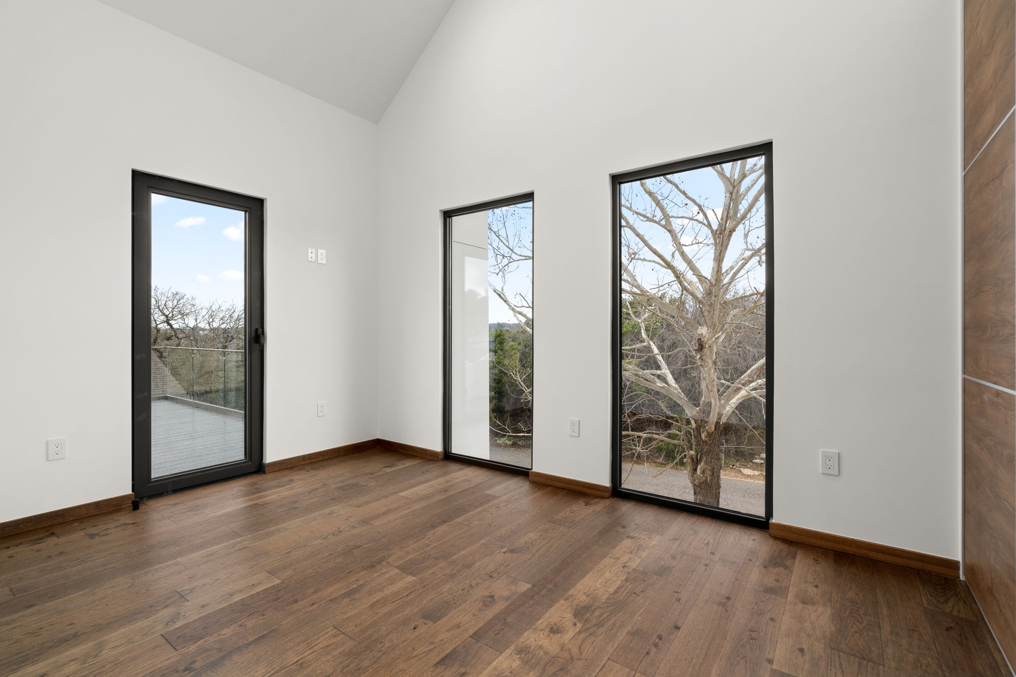 2915 Chisholm Trail Austin, TX 78734 - Photo 24 of 35 an empty room with large window and wooden floor