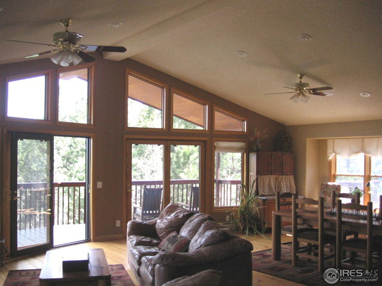 593 Crescent Lake Road Golden, CO 80403 - Photo 3 of 25 a living room with furniture ceiling fan and a large window