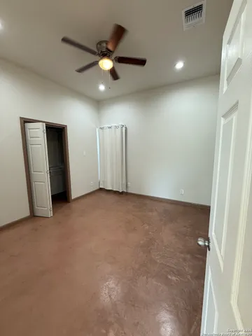 a view of a bathroom with sink mirror and window