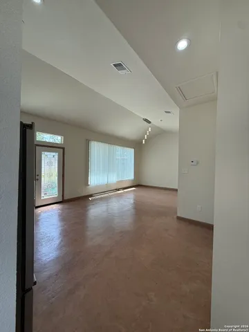 a view of an empty room with a window