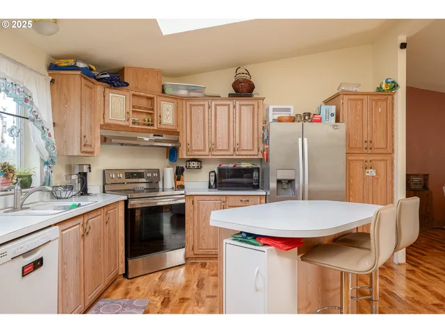 a kitchen with stainless steel appliances a stove a refrigerator and a refrigerator