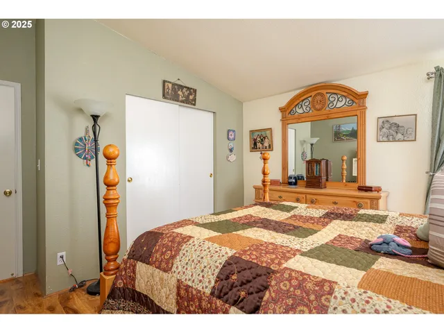 a bedroom with a bed and a mirror