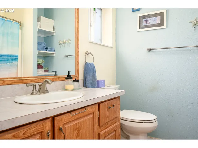 a bathroom with a sink a toilet and mirror