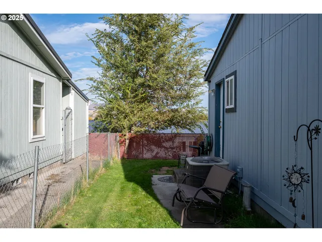 a backyard of a house with table and chairs