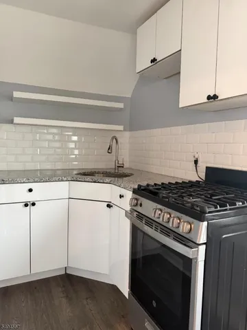 a stove top oven sitting inside of a kitchen