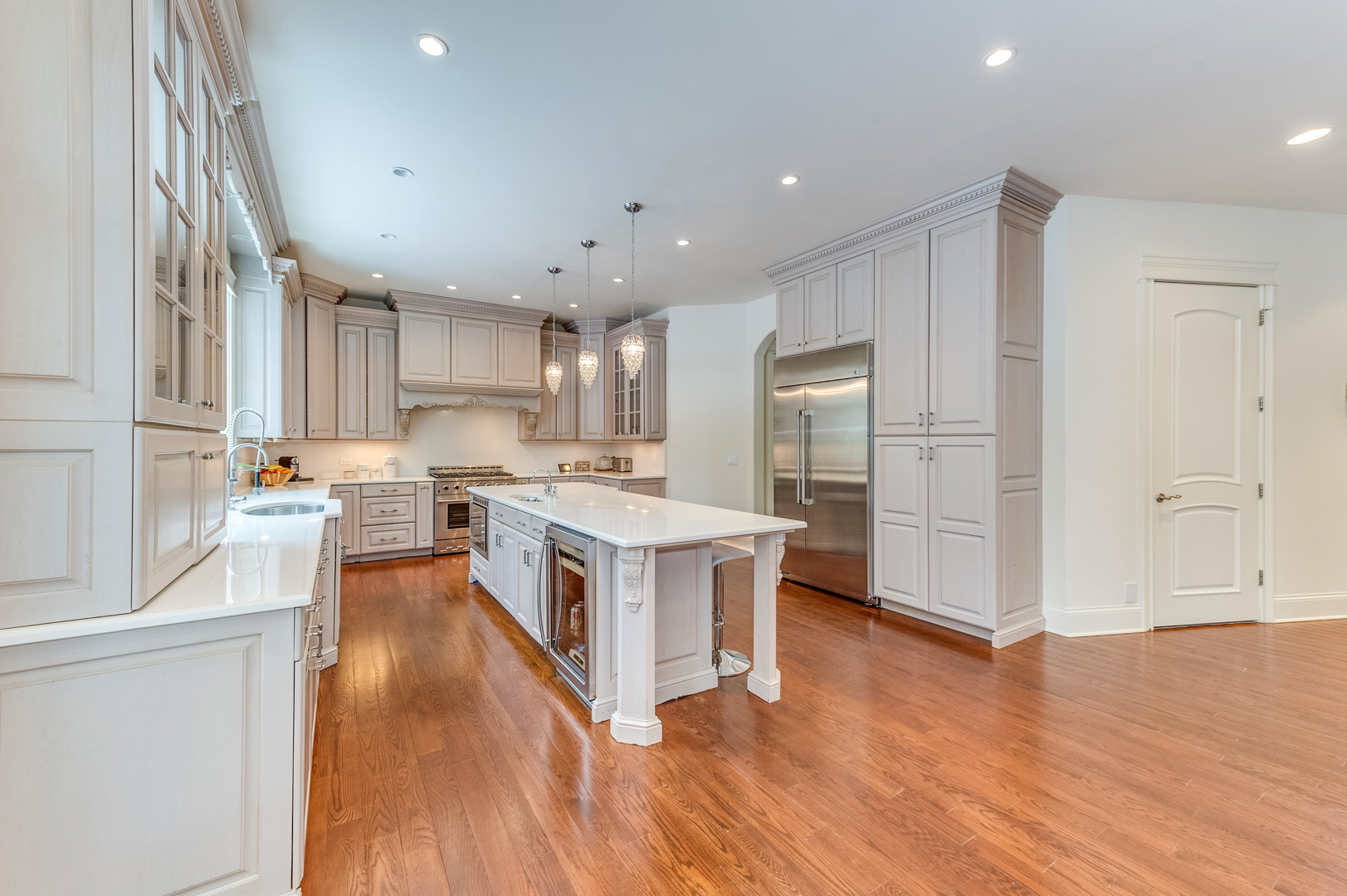 1450 Ridge Road Highland Park, IL 60035 - Photo 11 of 46 a large kitchen with stainless steel appliances granite countertop a large center island a sink a stove and a refrigerator