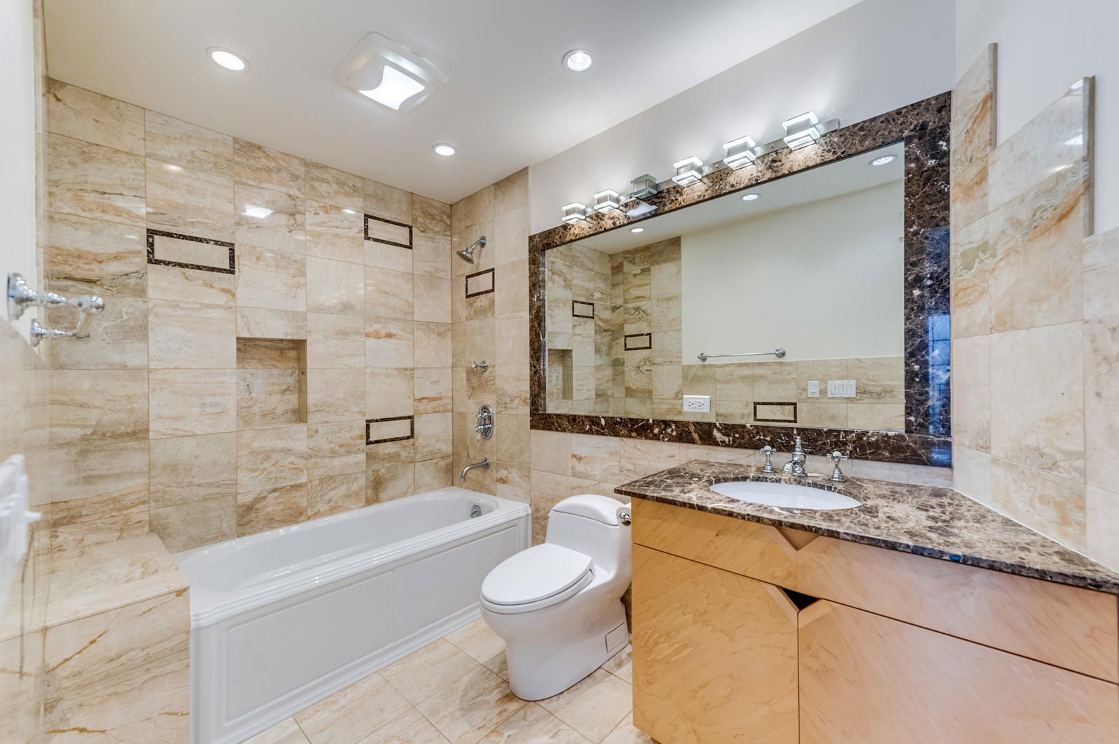 1450 Ridge Road Highland Park, IL 60035 - Photo 28 of 46 a bathroom with a granite countertop sink a toilet a mirror a bathtub and shower