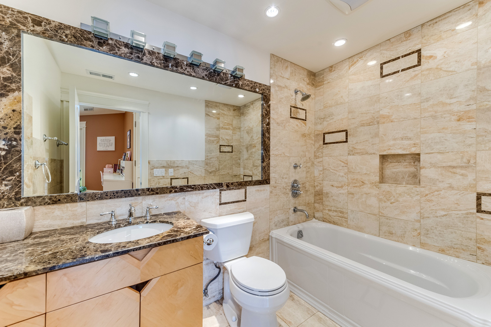 1450 Ridge Road Highland Park, IL 60035 - Photo 31 of 46 a bathroom with a granite countertop sink a toilet a mirror a bathtub and shower