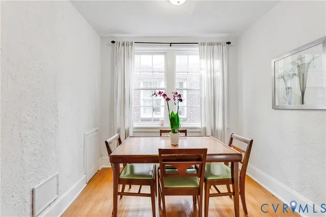 a dining room with furniture and window