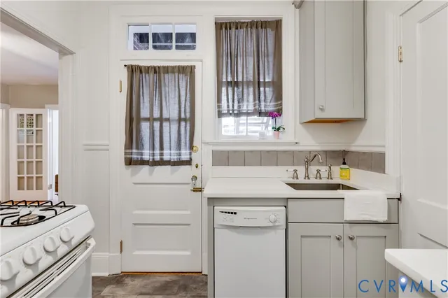 a kitchen with a sink stove and cabinets