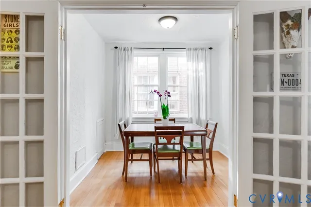 a view of a dining room with furniture and wooden floor