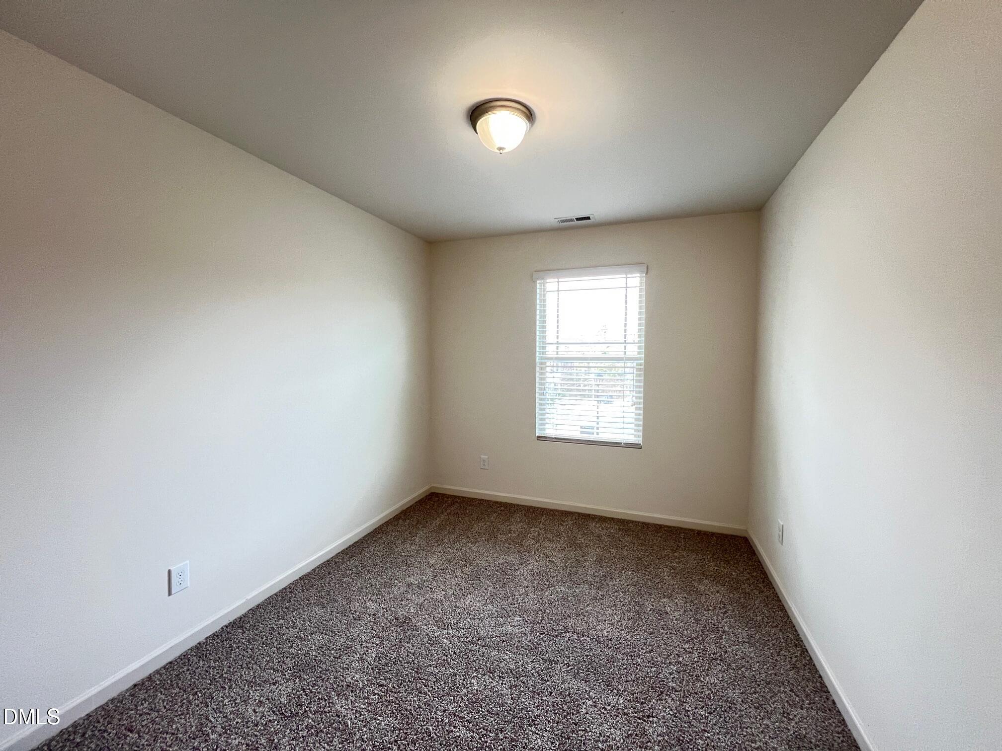 18 Rochambeau Court Durham, NC 27704 - Photo 11 of 12 an empty room with a window