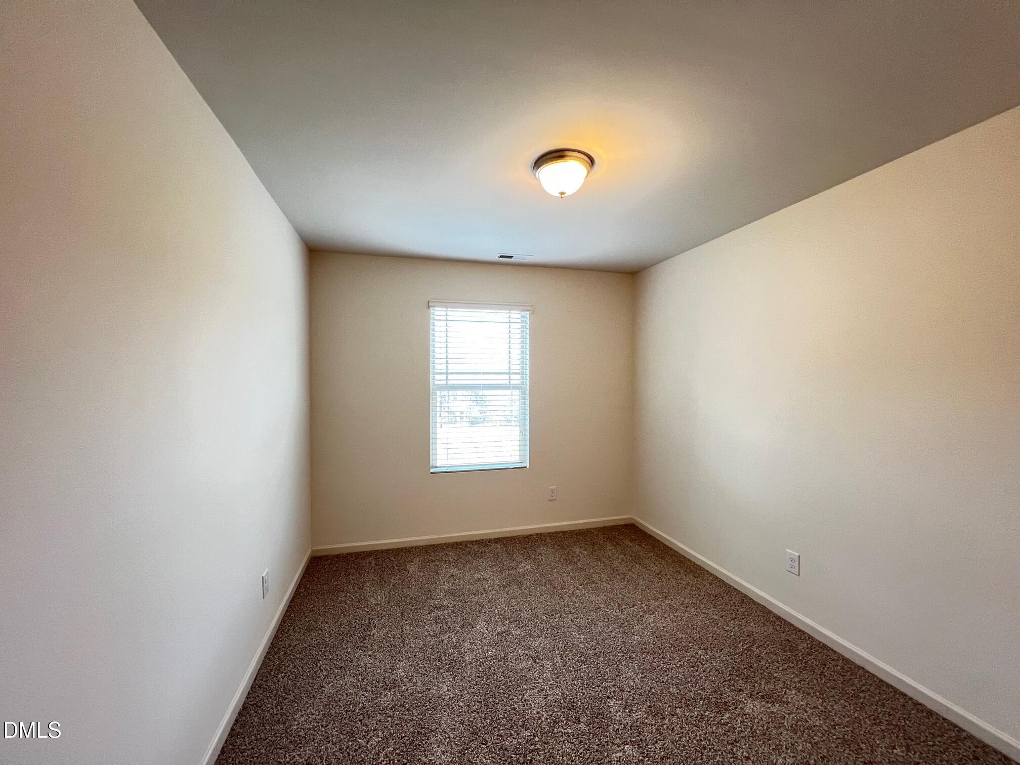 18 Rochambeau Court Durham, NC 27704 - Photo 10 of 12 an empty room with a window