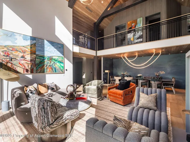 a large white tub sitting next to a bathroom sink and a window