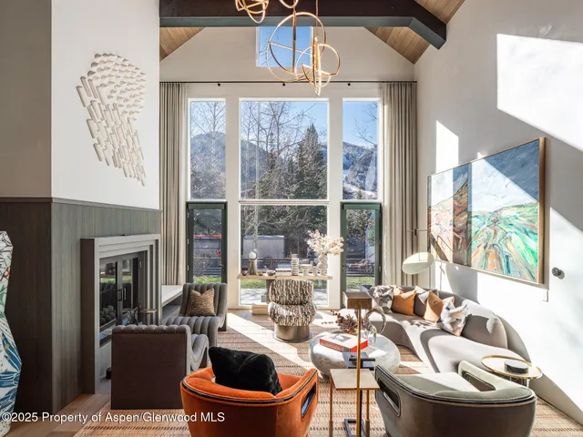 a living room with lots of furniture and kitchen view