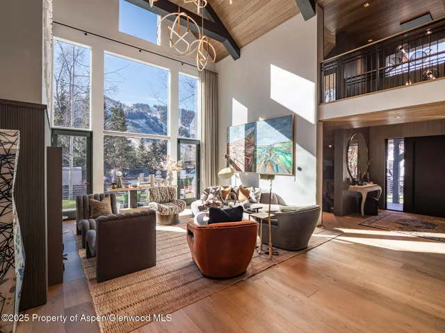 a living room with lots of furniture and view of kitchen