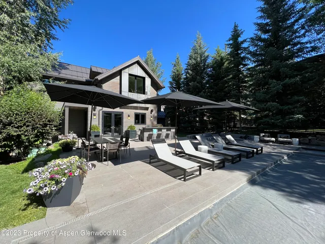 a living room with furniture fireplace and a large window