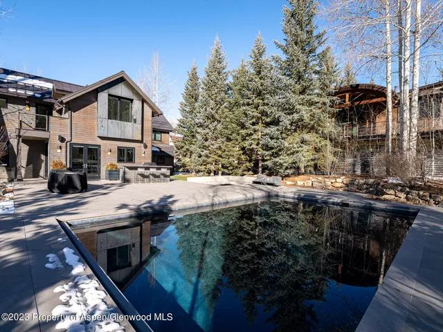 a living room with furniture a air conditioner vent and a windows