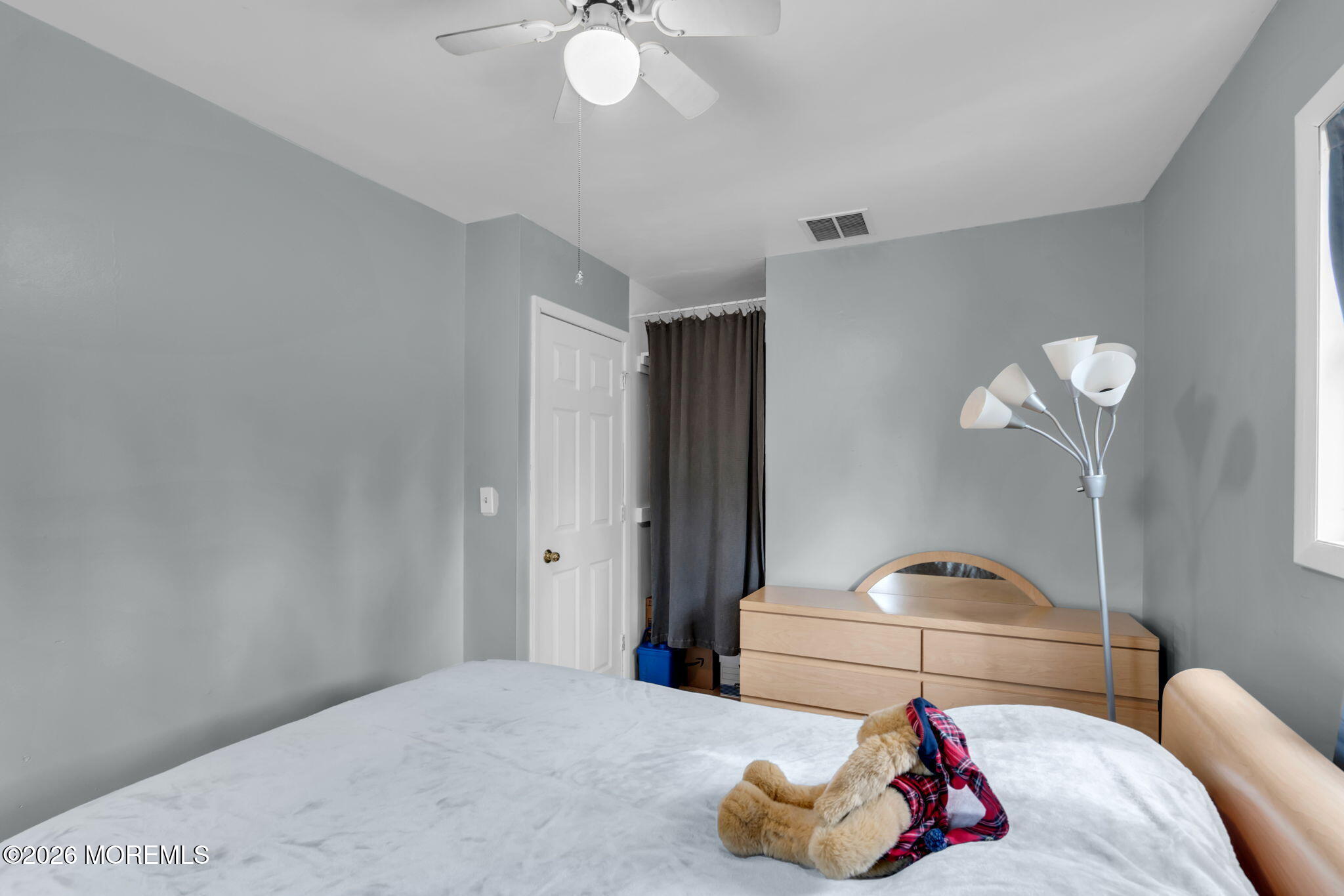 26 Clark Drive Howell, NJ 07731 - Photo 15 of 25 a bedroom with a bed and a chandelier