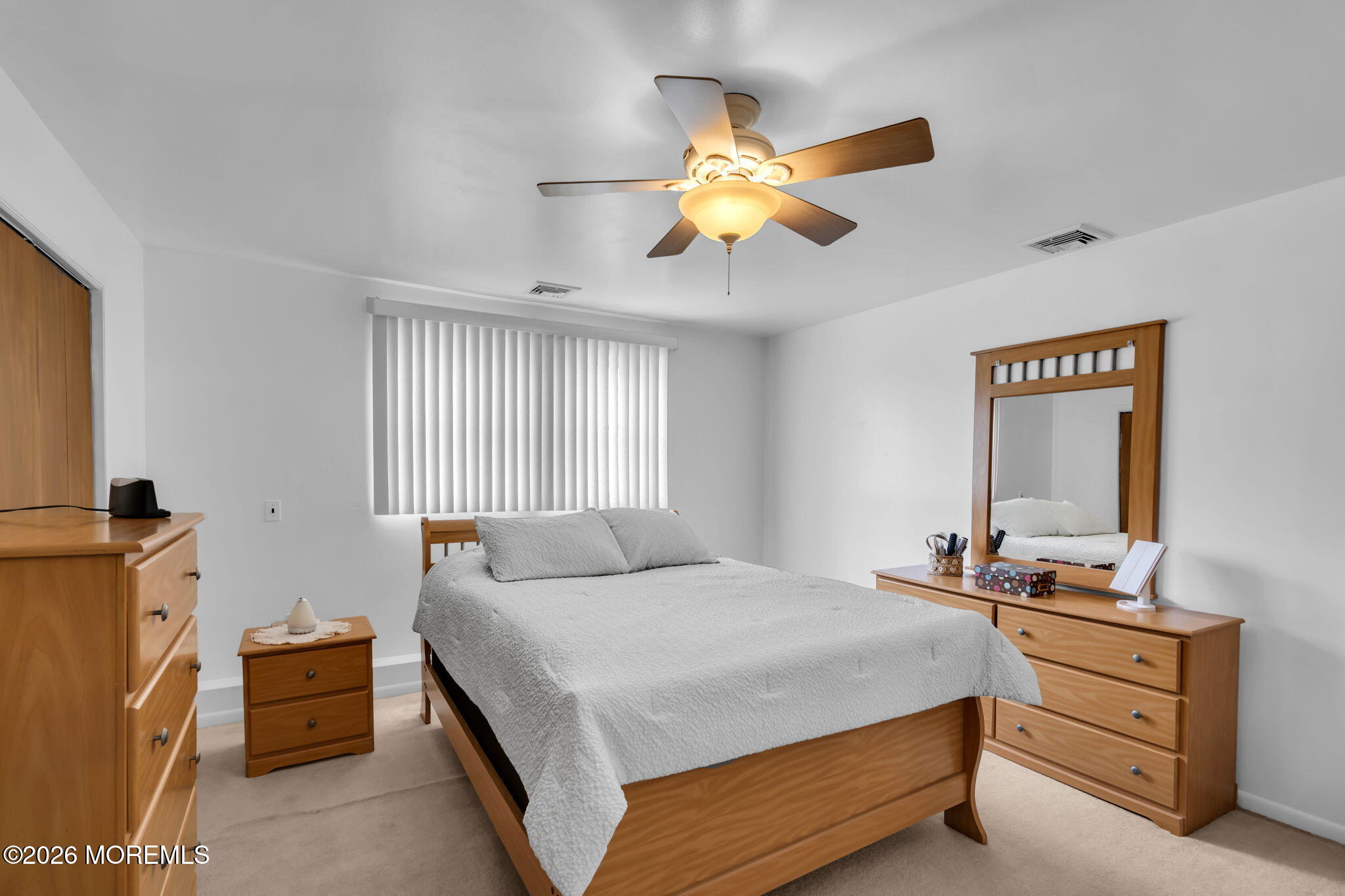 26 Clark Drive Howell, NJ 07731 - Photo 19 of 25 a bedroom with a bed and a chandelier