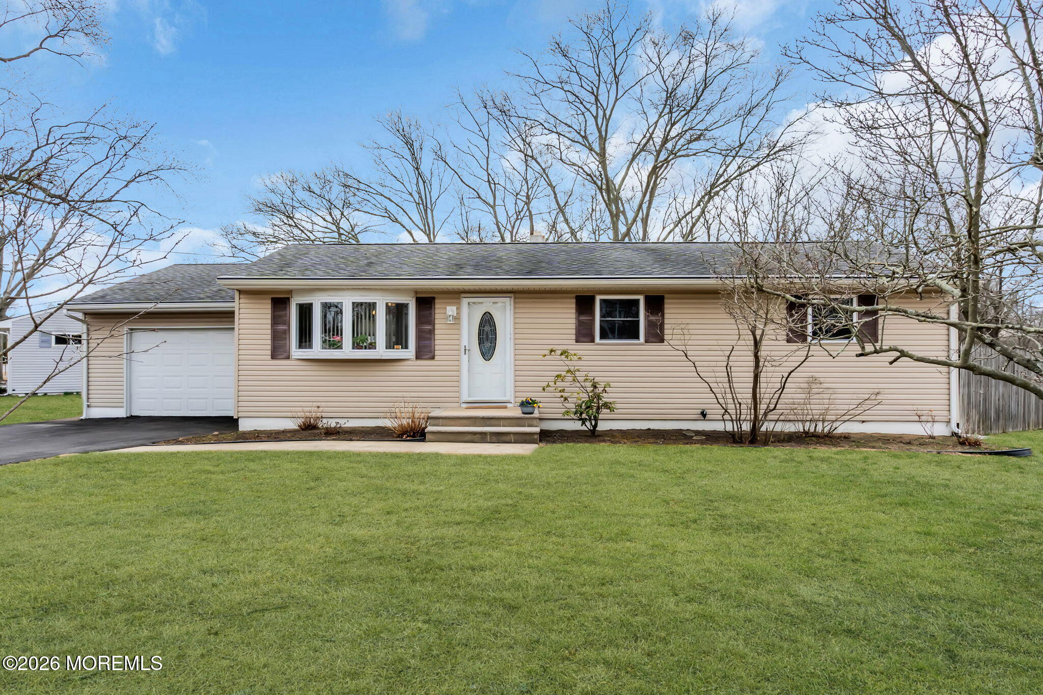 26 Clark Drive Howell, NJ 07731 - Photo 2 of 25 a white house that has a tree in front of it