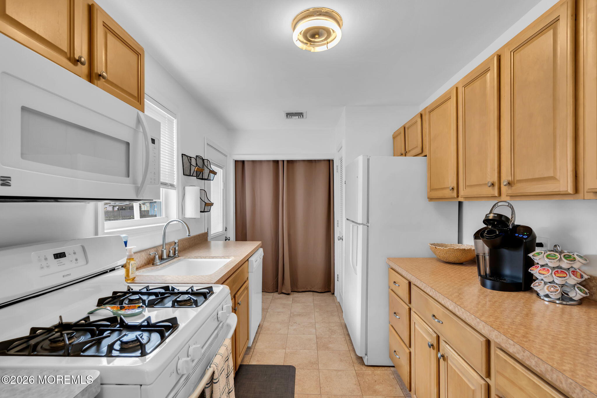 26 Clark Drive Howell, NJ 07731 - Photo 7 of 25 a kitchen with a stove a sink and a refrigerator