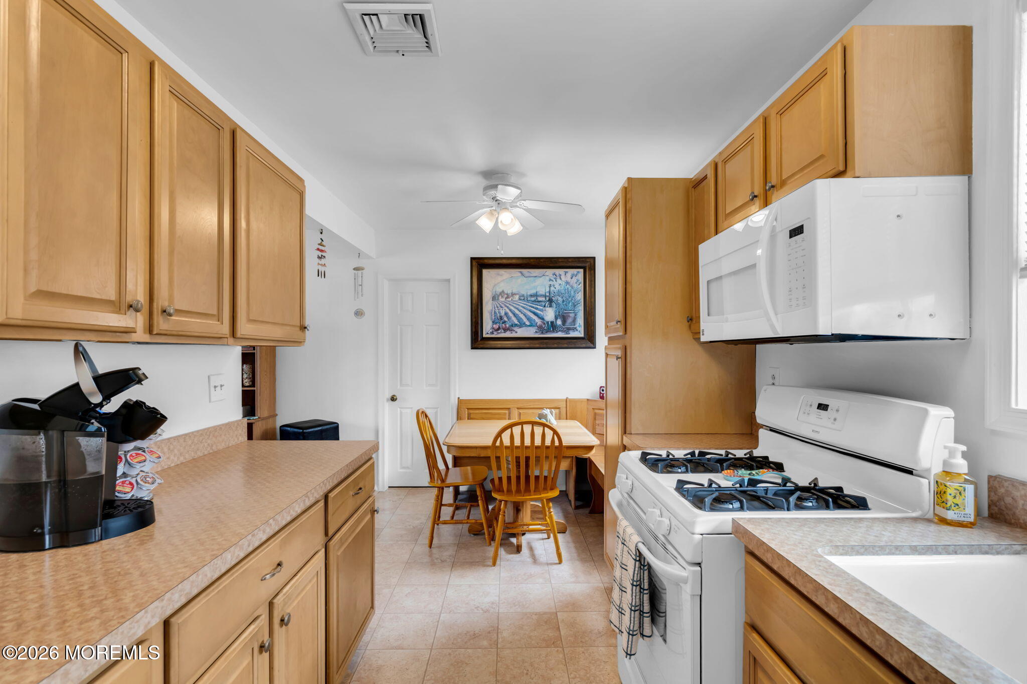 26 Clark Drive Howell, NJ 07731 - Photo 8 of 25 a kitchen with cabinets and stove top oven