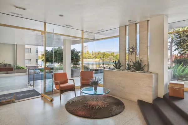 a lobby with furniture and floor to ceiling window