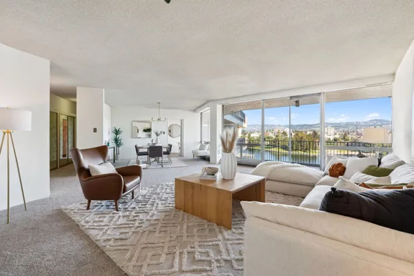 a living room with furniture and a potted plant