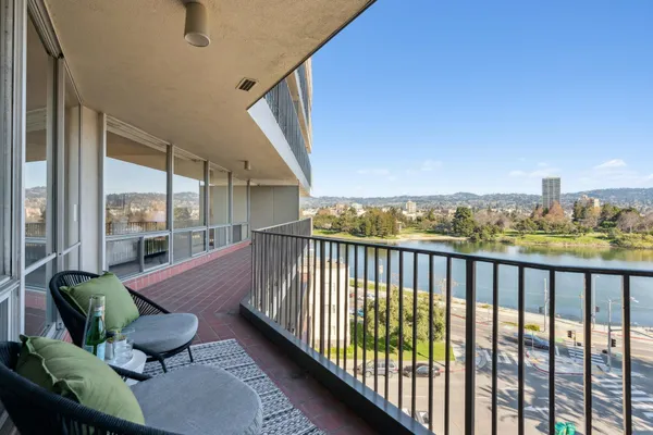 an aerial view of residential houses with outdoor space and lake view