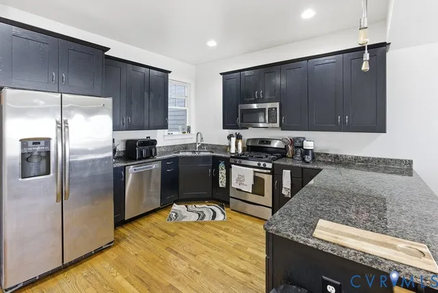 a kitchen with granite countertop stainless steel appliances and wooden cabinets