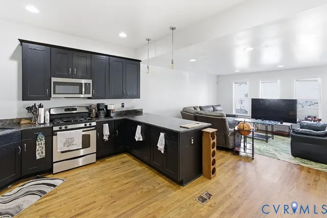 a kitchen with stainless steel appliances wooden cabinets and granite counter tops