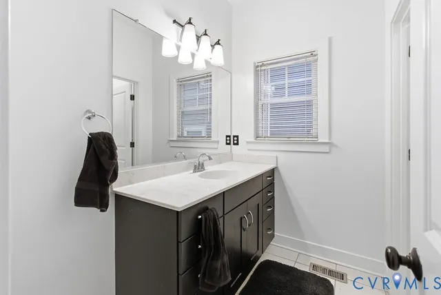 a bathroom with a sink a vanity and a mirror