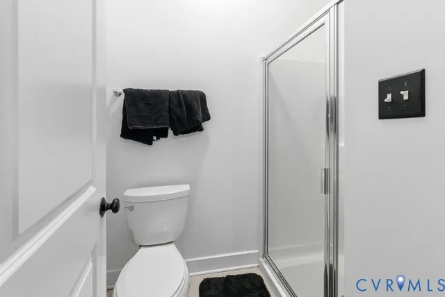 a bathroom with a toilet and a shower