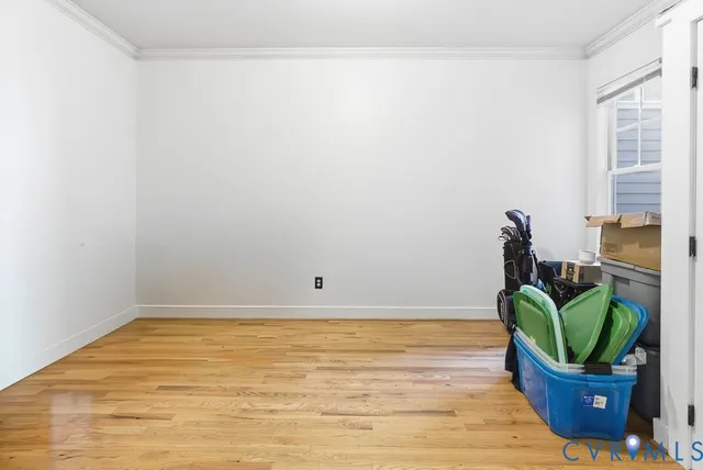 a view of a small space with wooden floor and a potted plant