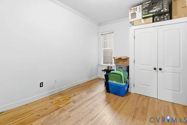 a room with bed and wooden floor