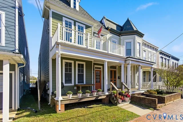 a view of a building with a large window and sitting area