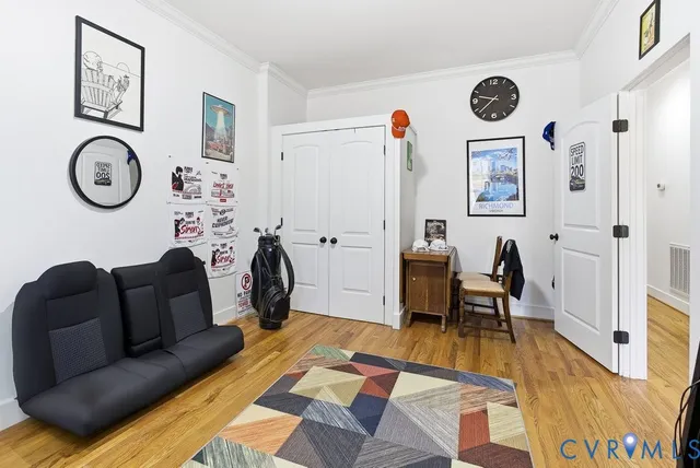 a living room with furniture a clock on wall and a window