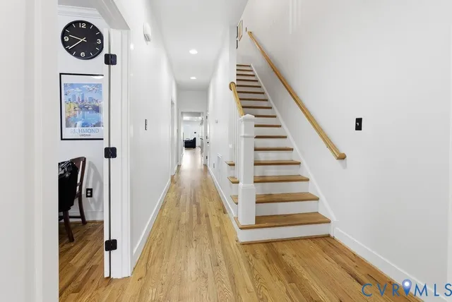 a view of a hallway with wooden floor