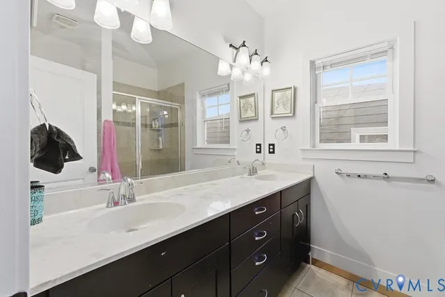 a bathroom with a sink double vanity and a mirror