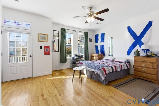 a bedroom with a bed and wooden floor