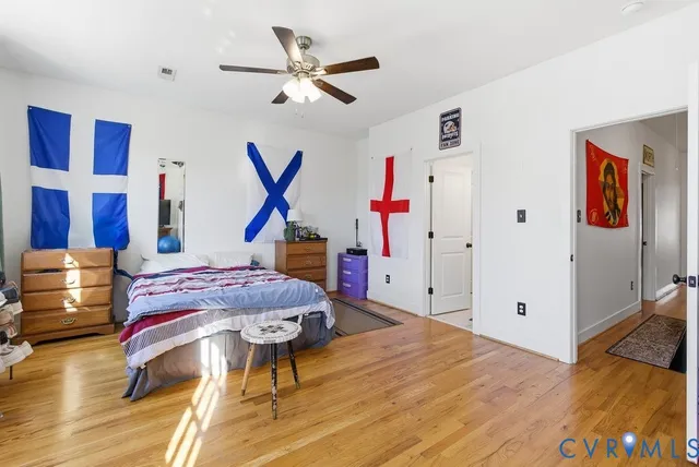 a bedroom with furniture and a wooden floor