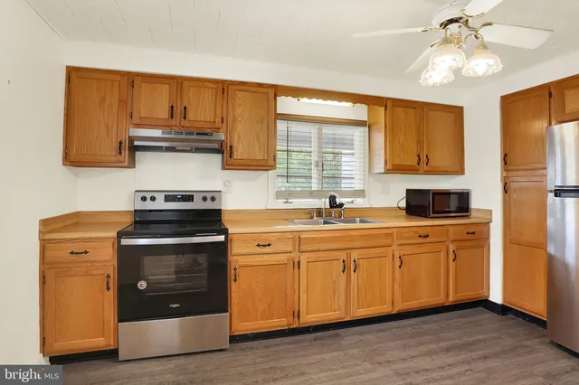 a kitchen with a stove cabinets and a sink