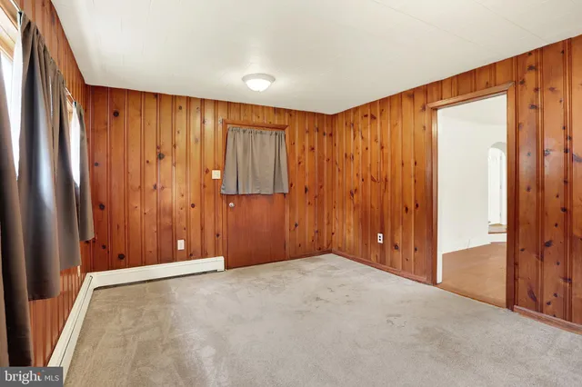 a view of an empty room with wooden walls