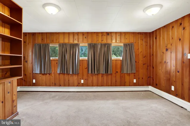 an empty room with sliding door and wooden floor
